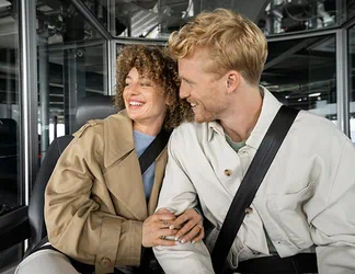 Happy couple on a ride in the car tower