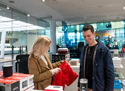 Man and woman stroll through the Volkswagen accessories store
