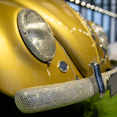 Close-up of the headlights and bumper of the millionth Volkswagen