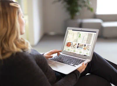 Woman sitting at laptop and has opened online store