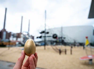 Small golden Easter egg in front of climbing frame