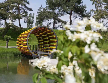 A round tunnel of pots with plants that you can walk through